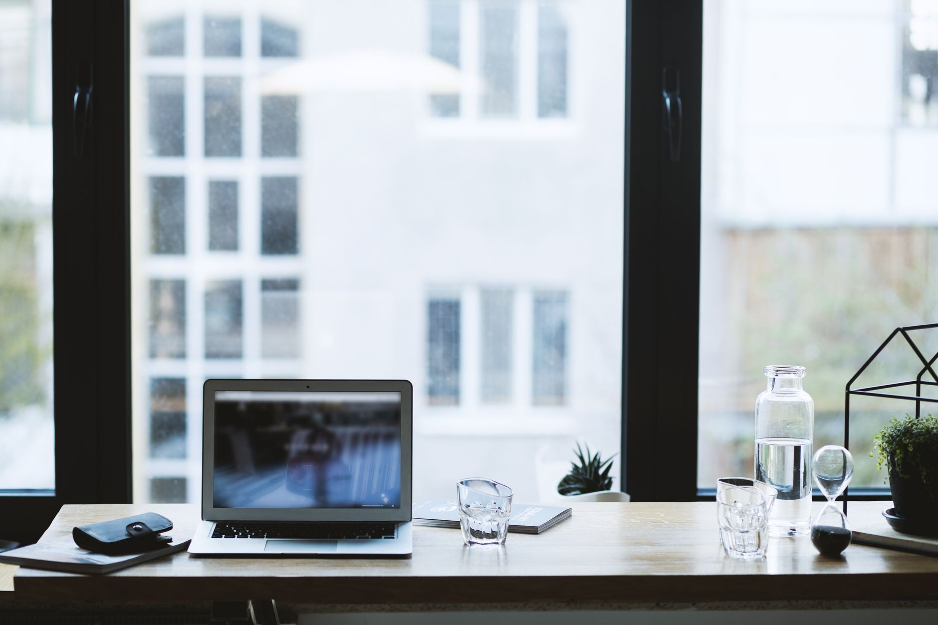 Laptop and water glass on the desk where blocks are copied